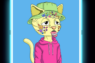 A screenshot from the nudiecommunity.shop website showing a Nudie Community NFT cartoon cat with stickers on its face and tongue which is sticking out, yellow skin, a pink hoodie, a green bucket hat and a blue background.