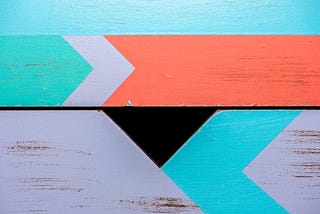 Painted arrows on wood facing different directions