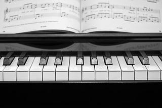 Close-up of piano with sheet music