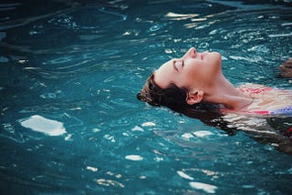 Woman swimming on her back in the ocean