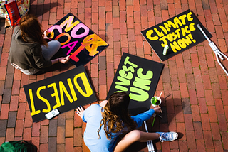 Students paint signs for the UNC Climate Strike.