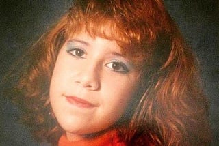 A picture of the author in 1988, complete with orange hair and garish makeup.