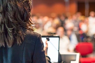 A female expert talks to an audience