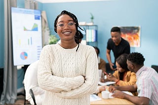A smiling black woman in an office