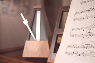 An analog metronome and some sheet music