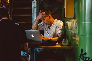 A man working on a laptop in a cafe