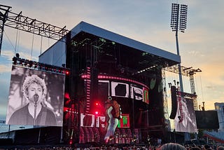 The band Green Day on stage at Emirates Old Trafford in Manchester. On the big screen is front man Billy Joe Armstrong