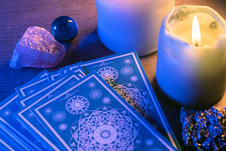 Tarot Cards with candles and crystals.