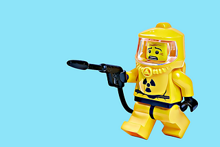 Lego person in a hazmat suit, looking worried.