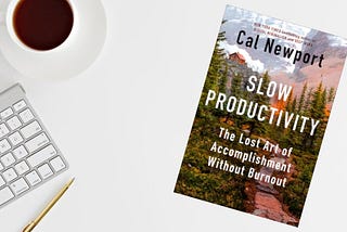 image of desktop with coffee cup and the book Slow Productivity by Cal Newport