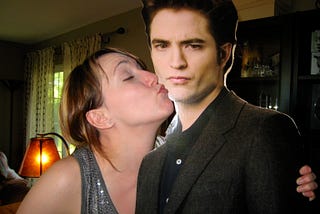 Woman kissing a life-sized cut out of Edward Cullen.