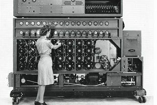A woman adjusting a large machine