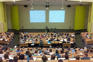 Students sitting in a college lecture during class.