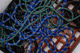 Tangled blue and green rope on a container