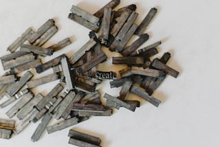 A pile of letter presses, with “create” spelt out