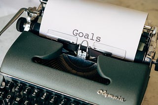 Image of a typewriter with the word “goals” in the paper.