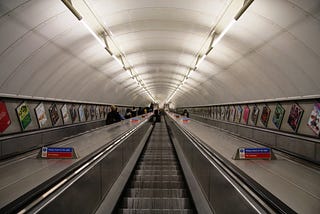 A view down from the top of the escalator leading to the Angel station on the London Underground.