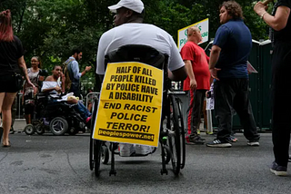 A man in a wheelchair protesting police terror against people with disabilities | Source: The New York Times (NYT)