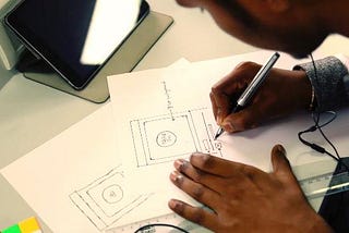 A Kustard team member sketching wireframes