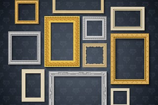 Display of frames of different sizes, orientations, and colors on a wall with a dark grey wallpaper