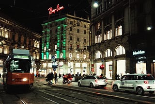 Night streets of Milan under the red lights of Ray Ban.