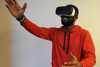 Man wearing a virtual reality head-mounted display gesturing with his hands