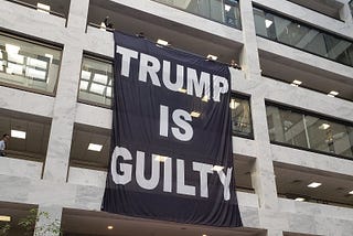 trump is guilty banner in senate office bldg