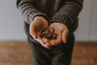 Person holding a hand full of pennies