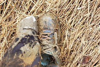 Two muddies shoes, one dug up from two feet of mud.