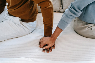 Husband and wife holding each other hands