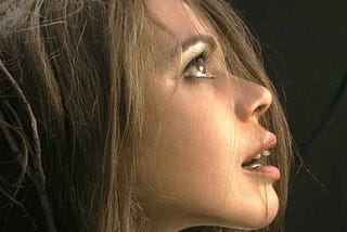 A woman looking up with her brown eyes