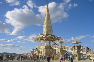 An intricate wooden temple in the middle of a desert city