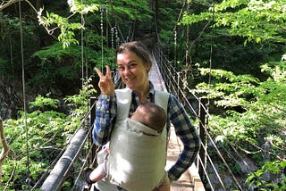 A photo of me and my daughter out the back of the ryokan on a bridge between the trees.