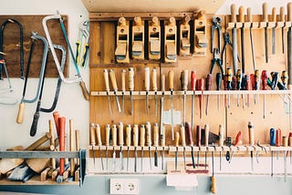 Carpenters workshop with tools on rack.