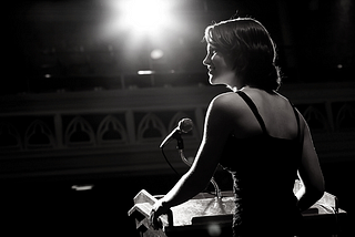 Woman delivering speech at podium