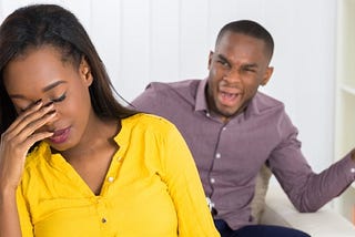 A male wearing purple long sleeves being angry with a female wearing yellow