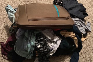 Suitcase with clothing falling out