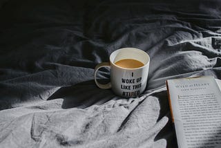 Coffee mug that says “I woke up like this #tired” | Image from UnSplash | Toa Heftiba@heftiba