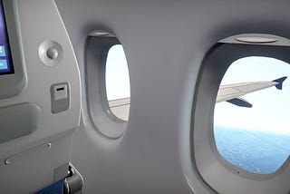 A plane window looking over a wing