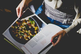 Person holding open a cookbook