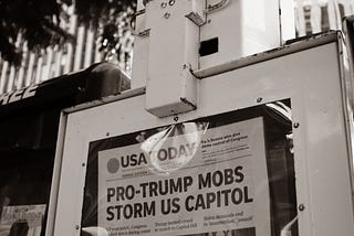 newspaper with headline Pro-Trump Mobs Storm US Capitol