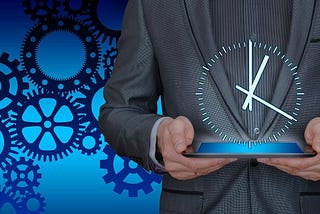 A man holding an iPad with an image of a clock superimposed in front of him to insinuate the time value of productivity