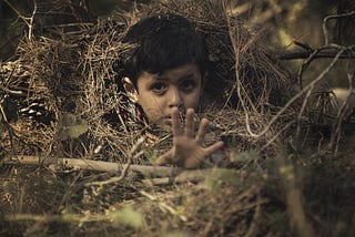 A creative portrait photograph of a cute indian kid to portray the sadness in children as a symptom of depression