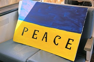 Sign of Ukraine’s flag with “peace” written on it