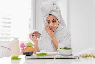 A woman applying best natural remedies for acne treatment.