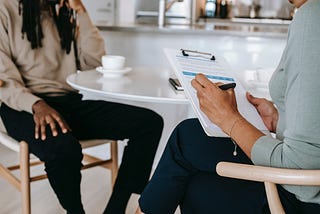 An photo over the shoulder of an interviewer recruiting for a job. Pexels.com Alex Green