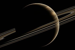 The planet Saturn with its rings in the dark sky.