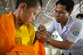 Young boy receiving a routine vaccine from a healthcare professional in a clinic, illustrating vaccine safety and pediatric immunization.