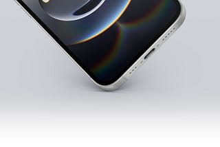 Close-up of the iPhone 16e’s bottom edge, showcasing the USB-C port, speaker grilles, and a sleek metallic frame. Credit: Apple.