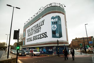 Ad on an entire side of a building reads: “You actually read this? Total success”